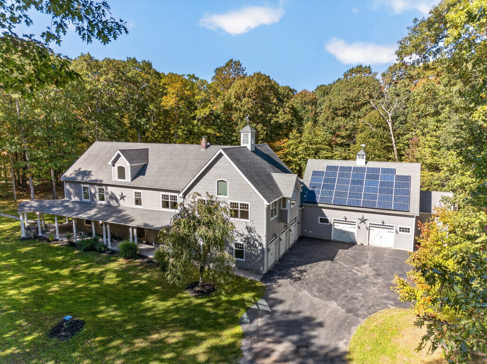 Original daylight aerial photograph of the house and garage.